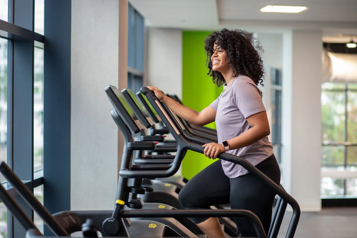 Woman tracking her workout on Technogym cardio equipment at LNPC