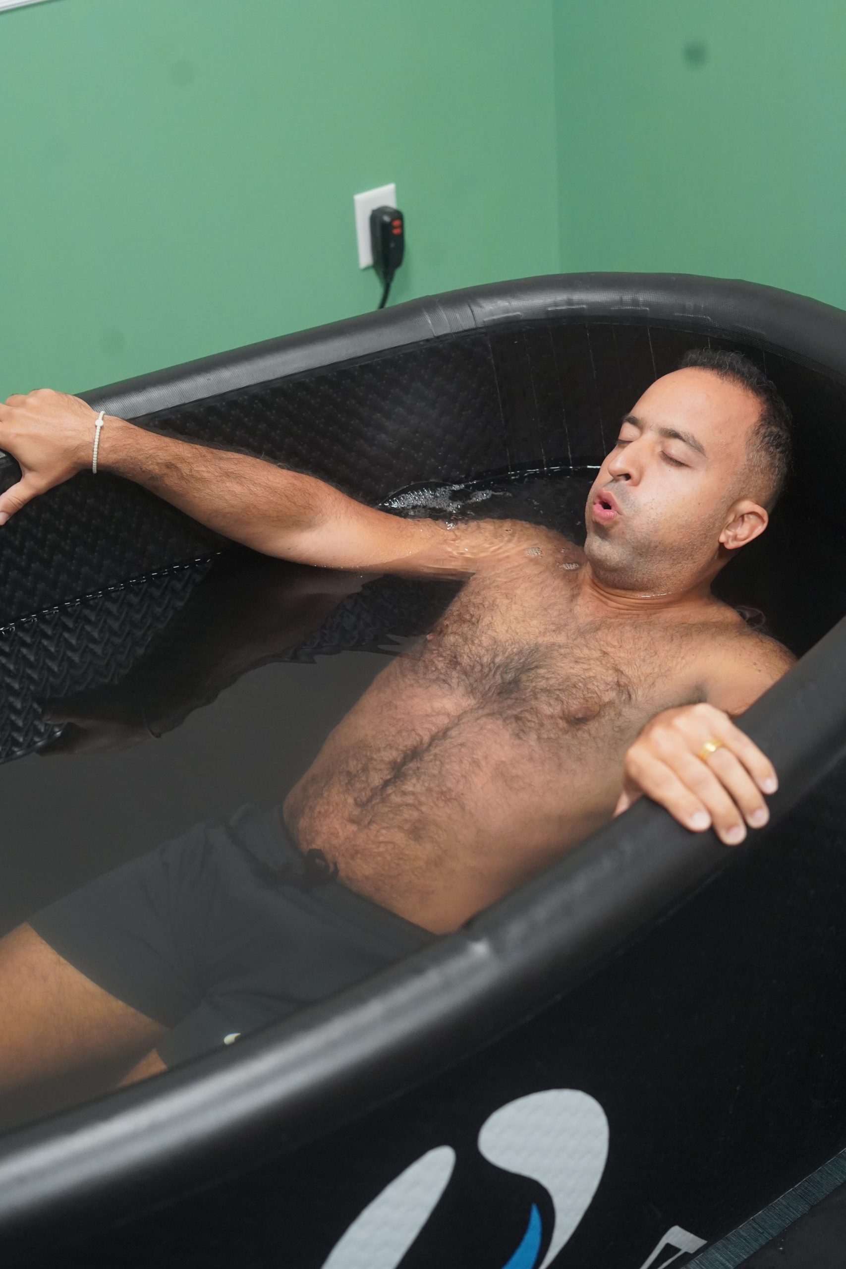 man enjoying a cold plunge in lake nona