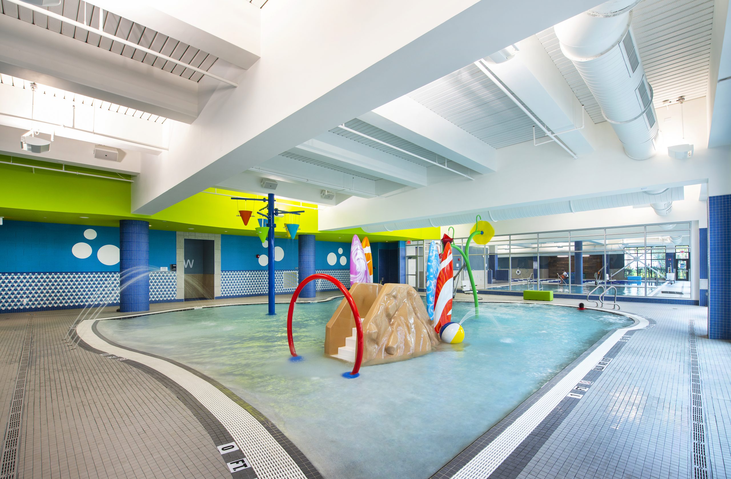 Zero-entry family pool with water slide and fountain features at LNPC