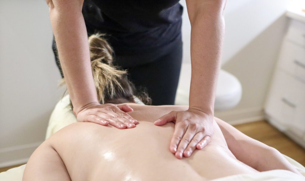 Classic massage therapy in Orlando with a massage therapist applying pressure to the upper back